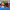Bright comic of a pumpkin-costumed grappler and a vampire-caped wrestler shaking hands on a blue mat at a Halloween open mat, with a werewolf giving a thumbs up and costumed teammates cheering, under the headline The Mat Keeps Score